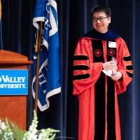 Bob Smart at podium, Provost and award recipient smiling